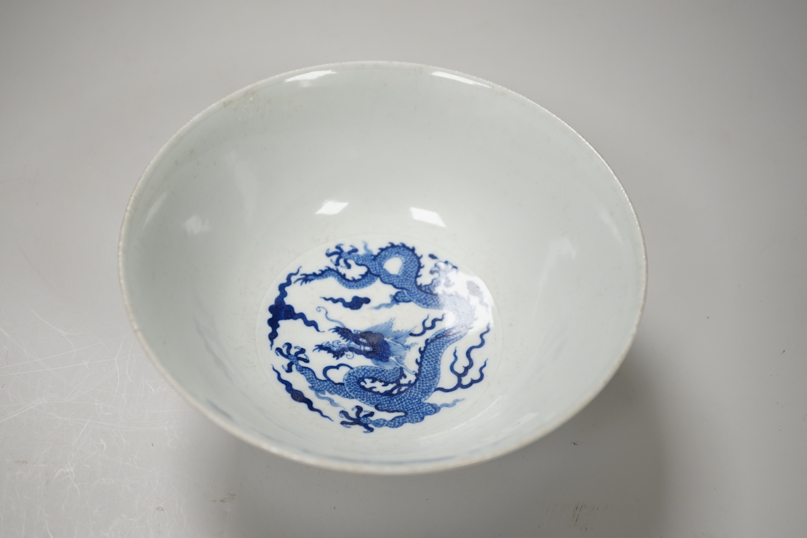 A Chinese blue and white bowl, hand painted with dragons, housed in a fitted case, 18cm in diameter